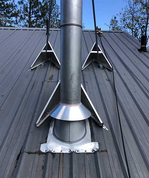 newly installed metal chimney on top of roof