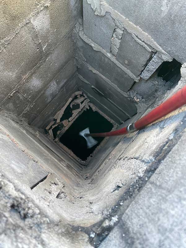 View down into a chimney with the flue tile showing