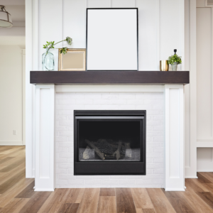gas fireplace with white framing and brown mantel