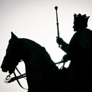 a silhouette of a king on a horse